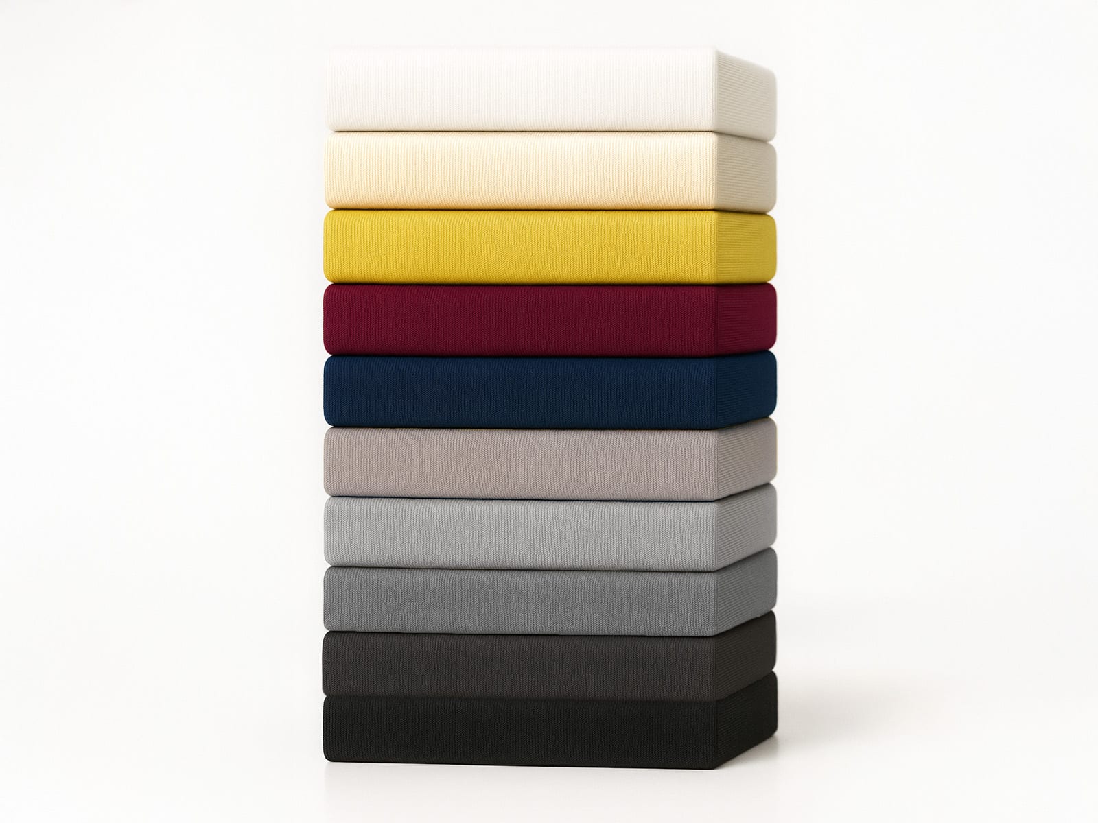 Stack of ten colored fitted sheets in white, cream, yellow, red, blue, gray and black